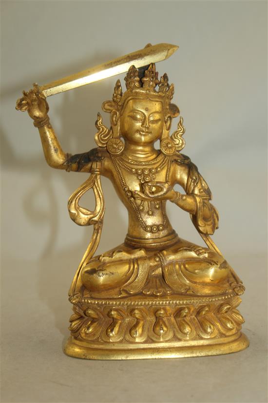 A Tibetan gilt bronze figure of Manjushri, 18cm